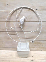 Round metal support stake featuring a playful bird design, perfect for garden decor and plant support.