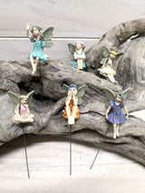 Set of 6 whimsical fairy picks with intricate designs for enhancing gardens, parties, or cake decorations.