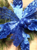 Vibrant blue metal and mesh poinsettia flower, elegant decor for home or garden, perfect for holiday celebrations.