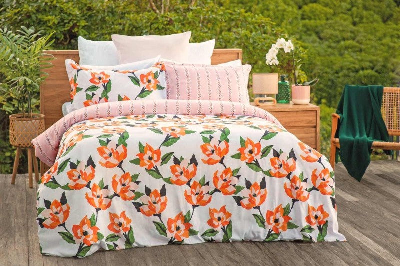 Hibiscus King duvet cover set featuring a vibrant retro floral print with pinks and oranges on a soft pink background.