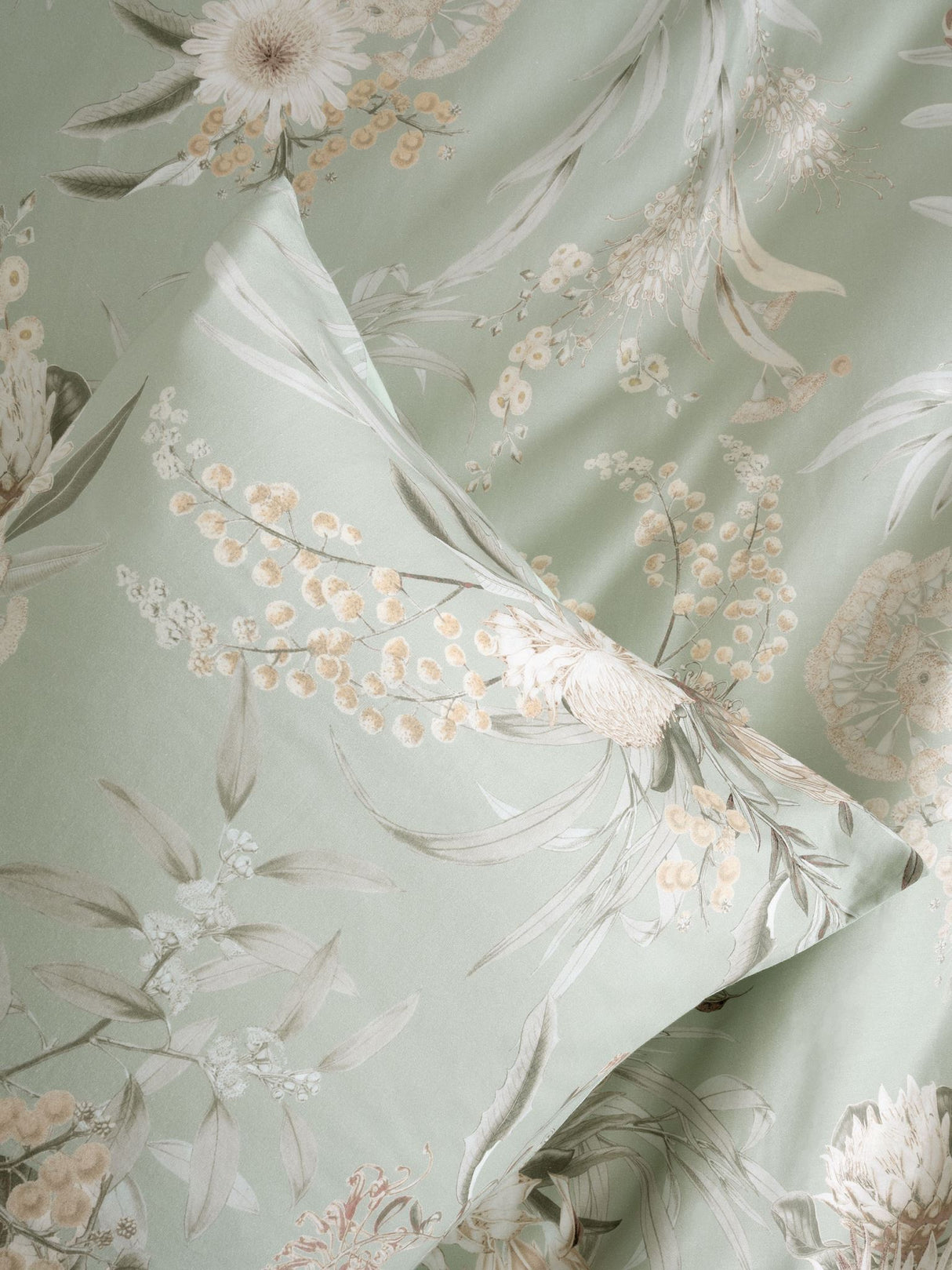 Nella Duvet Cover Set in sage featuring floral motifs, crafted from 100% cotton for a serene bedroom aesthetic.