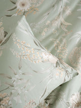 Nella Duvet Cover Set by Savona in sage green, featuring botanical designs and made from soft 100% cotton sateen for Queen beds.