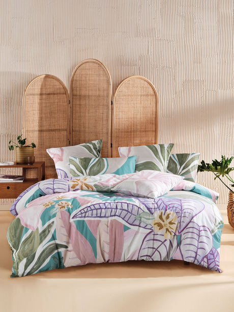 Vibrant hand-painted Palmetto duvet cover set featuring tropical foliage on a turquoise base, crafted from 100% cotton slub.