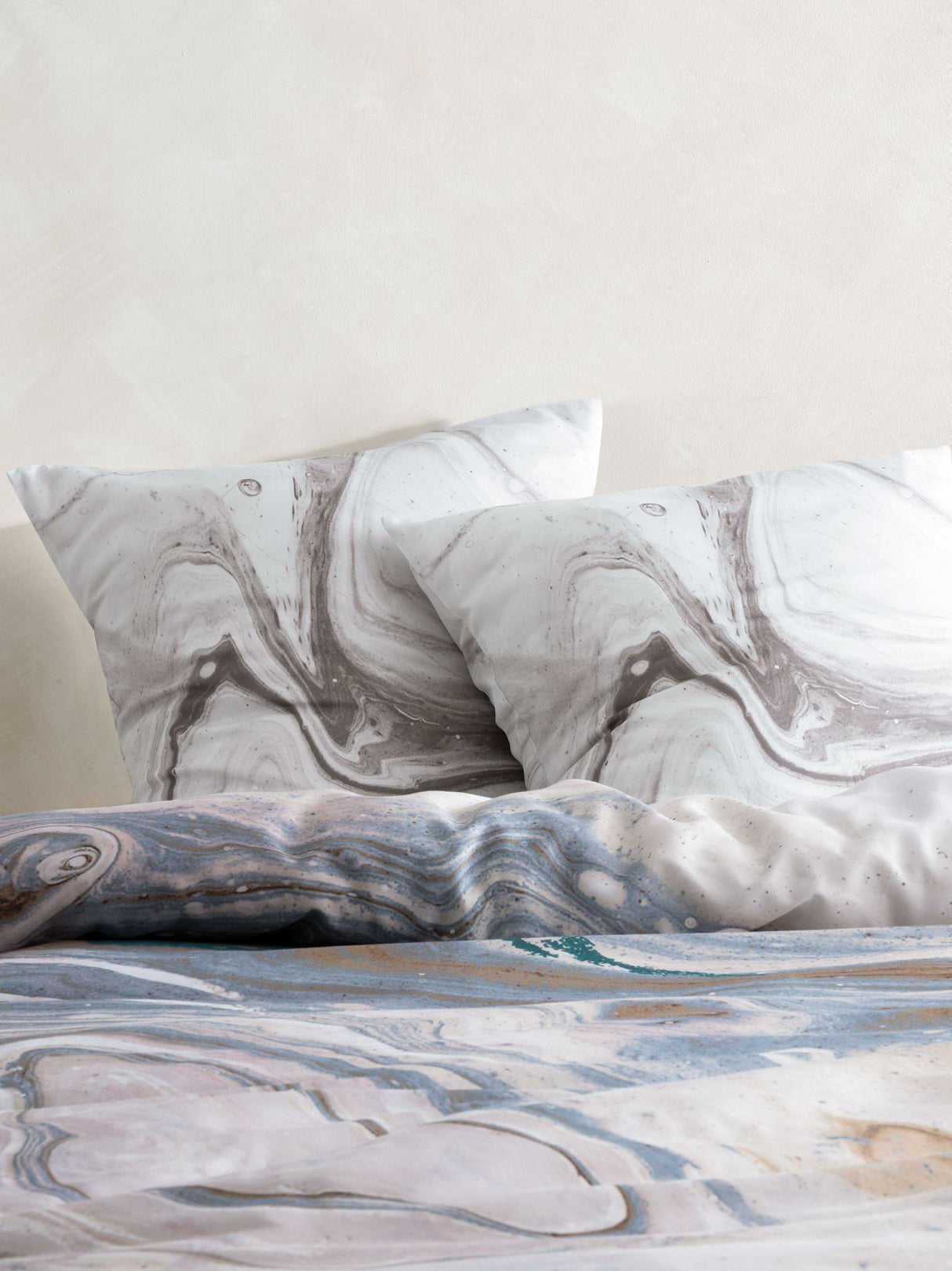 Super King Duvet Cover Set featuring a marble design in cotton sateen, with teal accents and includes pillowcases.