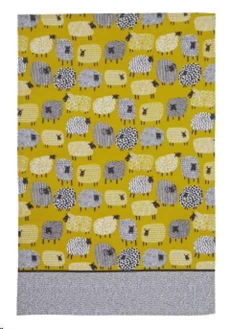 Cotton tea towel featuring a whimsical dotty sheep design, perfect for practical use and adding charm to your kitchen.