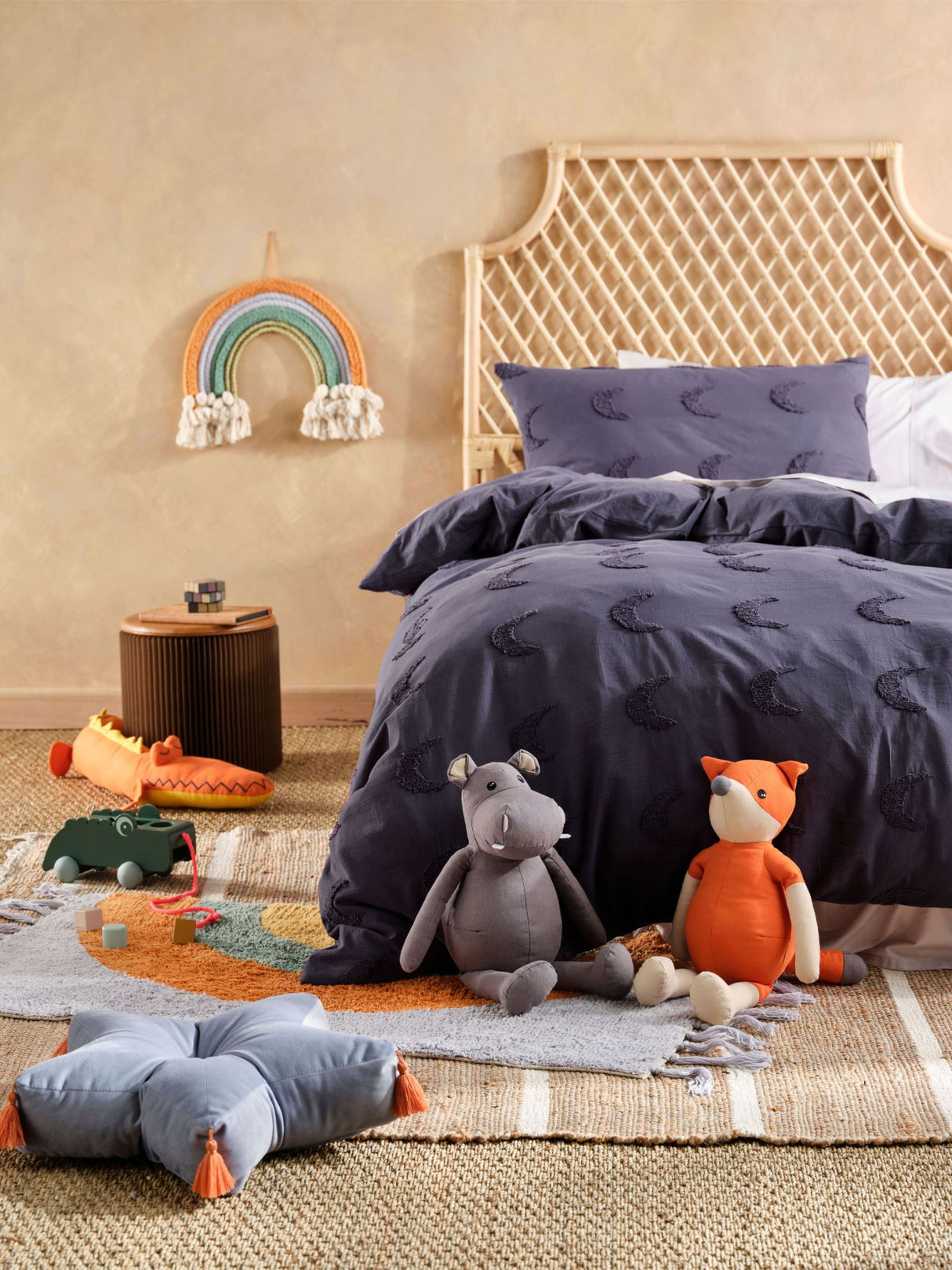 Single duvet cover set featuring tufted moons on navy background, perfect for cozy kids' rooms by SQUIGGLES.