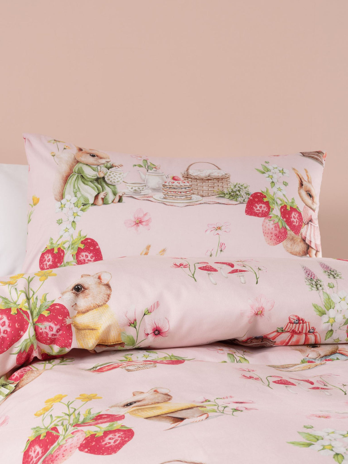 Double duvet cover set in blush featuring bunnies and strawberries, crafted from 100% cotton for cozy, playful bedding.
