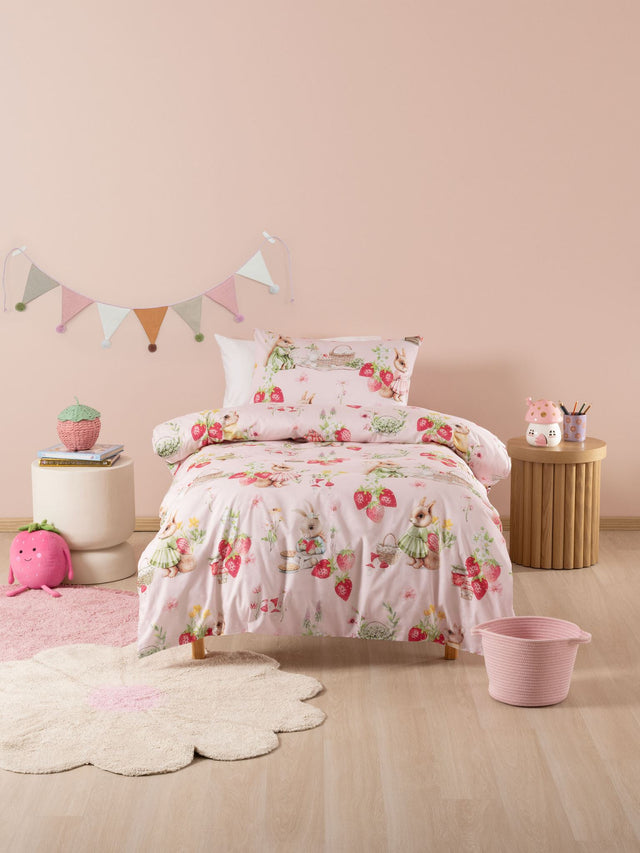 Whimsical blush duvet cover set with bunnies, strawberries, and picnics, crafted from 100% cotton for cozy sleep.