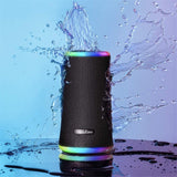 Portable black waterproof speaker with 360° sound, vibrant light show, and IPX7 rating for outdoor parties.