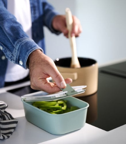 A sleek 1500ml white food storage box with airtight seal, steam vent, and stackable design for convenient kitchen organization.