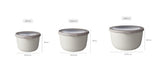 A set of three large, stackable Nordic white food storage bowls with airtight lids and transparent windows for stylish meal prep.