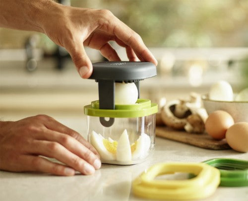 Compact Multi-Prep Mini slicer by Joseph Joseph, featuring three color-coded cutters for uniform slices of fruits and eggs.