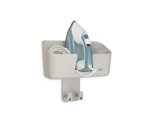 Wall-mounted ironing caddy with compartments for iron, cable, 350ml jug, and heat-resistant pad for a tidy laundry area.