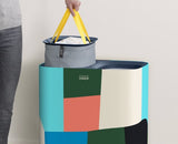 Tota 90L Laundry Basket by Joseph Joseph features dual compartments and fabric tote bags for efficient laundry organization.