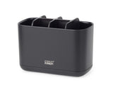 Elegant black toothbrush caddy with multiple compartments for organized oral care storage, featuring ventilation and a non-slip base.