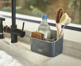 Stylish tiered sink tidy by Joseph Joseph, featuring three compartments for organized storage of washing-up items.