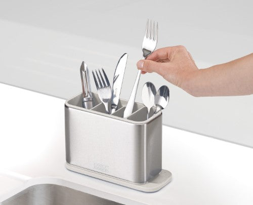 Stainless steel cutlery drainer with divided compartments, spout for drainage, and non-slip feet for organized kitchen drying.