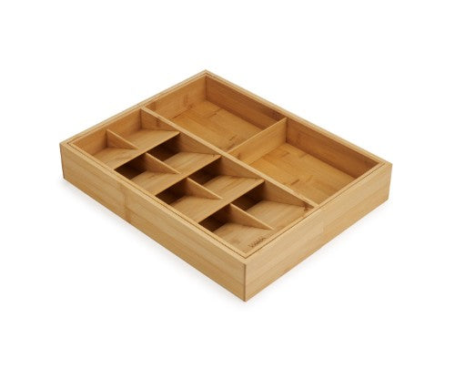 Bamboo drawer organizer featuring five overlapping cutlery compartments and two deep gadget slots for efficient kitchen storage.