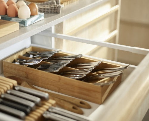 Bamboo cutlery organizer with overlapping compartments, non-slip feet, and cutlery icons for efficient drawer storage.