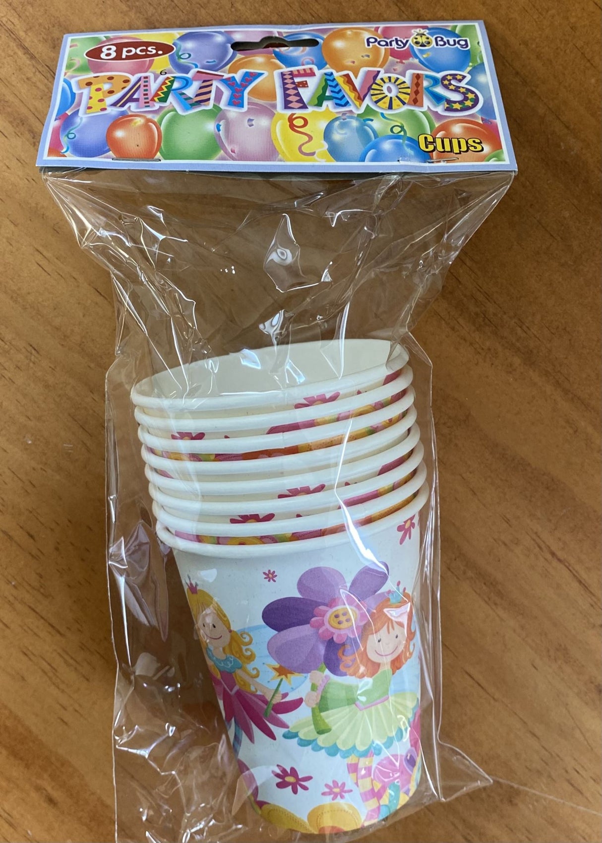 Whimsical paper cups featuring fairy and floral designs, perfect for children's parties and festive gatherings.