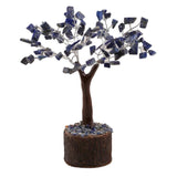 Lapis Lazuli crystal tree with 100 vibrant chips, 19cm tall, resting on a natural neem base for unique decor and spiritual use.