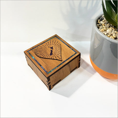 Elegant square trinket box with paua inlay, perfect for storing jewelry and keepsakes, measuring 80mm x 80mm x 45mm.