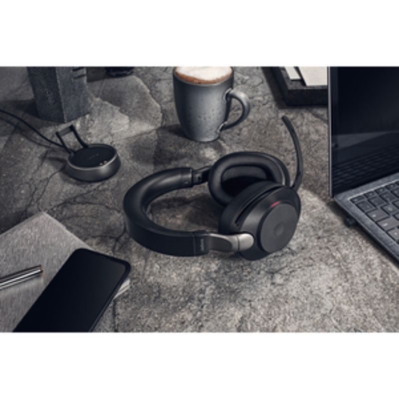 Jabra Evolve2 85 wireless headset featuring noise-canceling mics, over-the-head design, and charging stand, ideal for professionals.