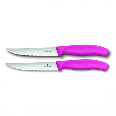 Pink Victorinox steak and pizza knife set, featuring 12cm wide blades with wavy edges for effortless slicing and ergonomic handles.