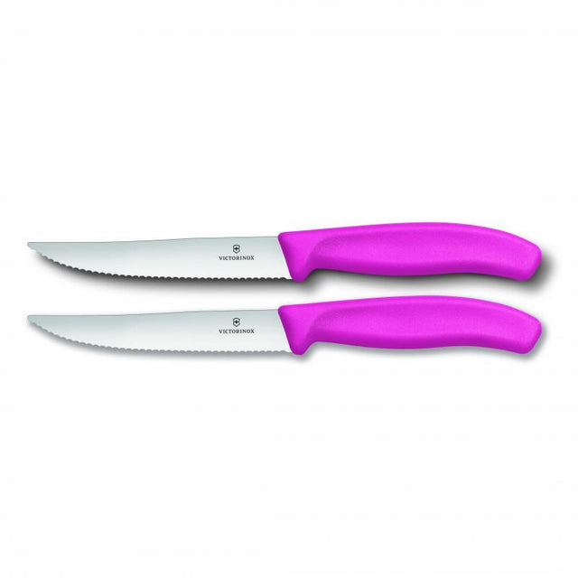 Pink Victorinox steak and pizza knife set, featuring 12cm wide blades with wavy edges for effortless slicing and ergonomic handles.