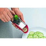 Versatile Victorinox Handslicer with red ergonomic handle, featuring slicer, julienne, grater, and peel holder for effortless food prep.