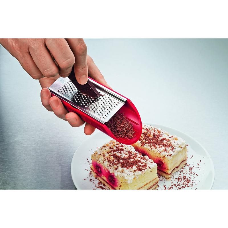 Victorinox Handslicer with red ergonomic handle, featuring double-edged slicer, julienne cutter, grater, and holder.