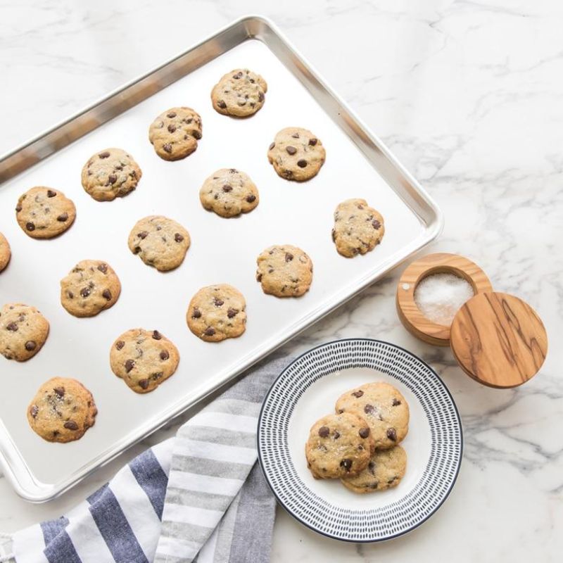 Nordic Ware Natural Full Sheet pan made of durable aluminum, perfect for baking cookies, cakes, and roasting vegetables.