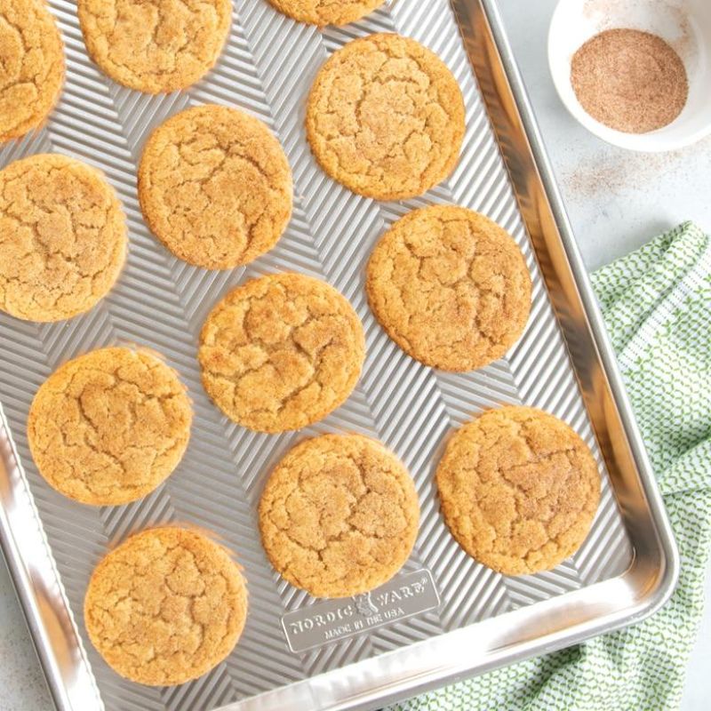 Nordic Ware Prism Half Sheet pan with embossed aluminum design for even baking, durable grid pattern, and galvanized steel rims.