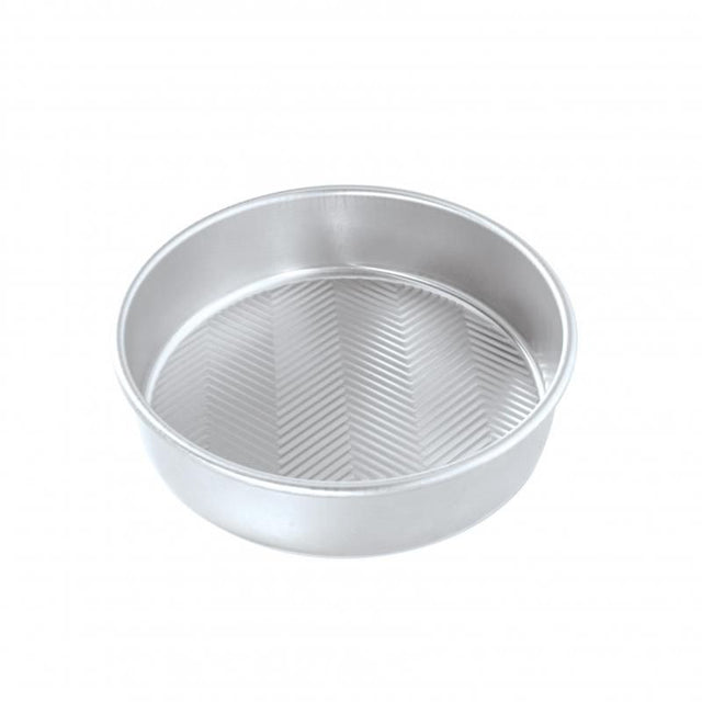 Nordic Ware 9" round layer cake pan with Prism embossed design for easy release and even baking; perfect for festive cakes.