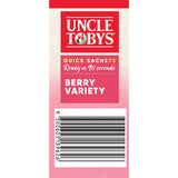 Bowl of creamy porridge with blueberries, strawberries, and triple berry mix in Uncle Tobys Oats Quick Berry Variety sachets.