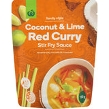 Woolworths Coconut & Lime Red Curry Stir Fry Sauce in a pouch, offering natural tropical flavors and mild heat for quick meals.