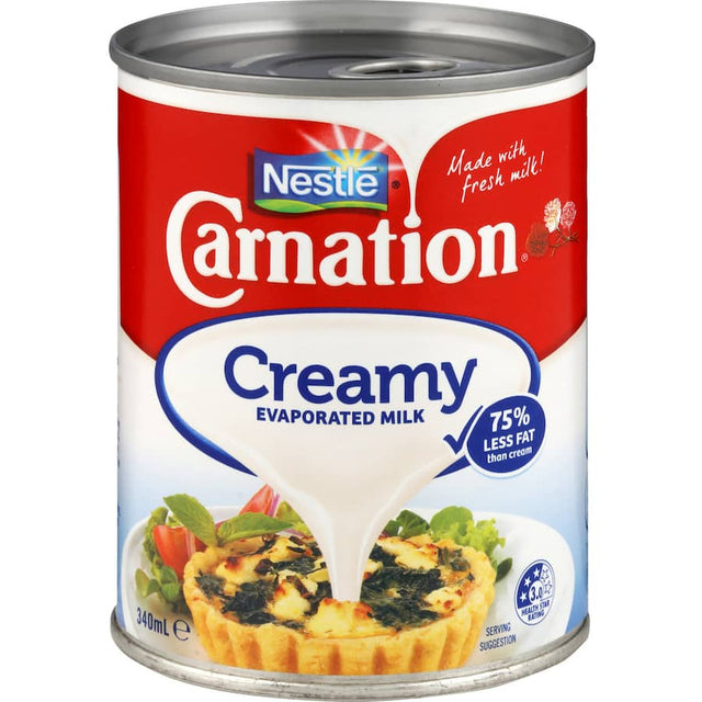 Creamy Carnation Evaporated Milk in a can, perfect for enhancing cooking and baking with rich flavor and smooth texture.