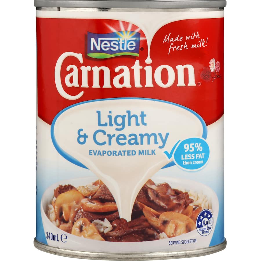 Carnation Evaporated Milk Light & Creamy, a low-fat, concentrated milk for enhancing savory and sweet dishes.