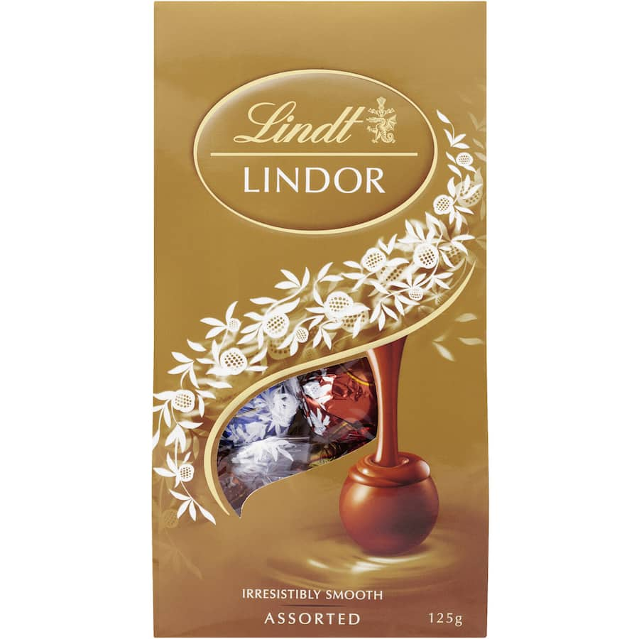 Assorted Lindt Lindor truffles featuring milk, dark, white chocolate, and hazelnut with a creamy, melting filling.