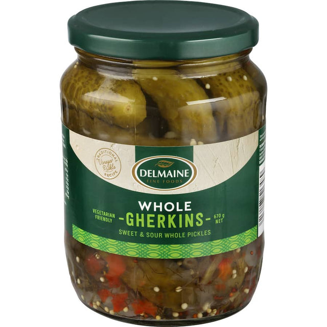 Delmaine Gherkins Whole in a jar, featuring mustard seeds, perfect for enhancing sandwiches and salads with a tangy crunch.