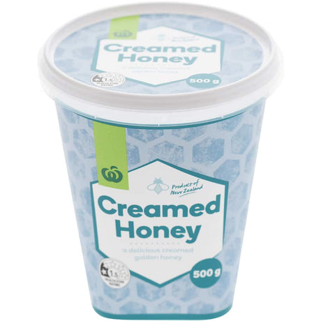 Woolworths Creamed Honey in a jar, showcasing its smooth texture and rich, natural sweetness for versatile culinary uses.