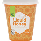 Golden Woolworths Liquid Honey in a clear bottle, perfect for sweetening meals and boosting health with natural goodness.