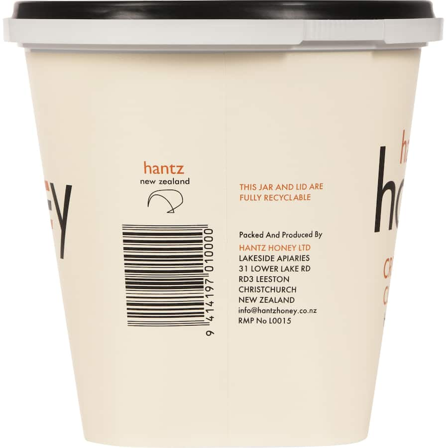 Creamy Hantz Clover Honey in a jar, showcasing its pale light color and thick texture, perfect for spreading and baking.