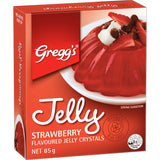 Bright red Greggs Strawberry Jelly crystals ready to mix with boiling water for quick, delicious desserts.