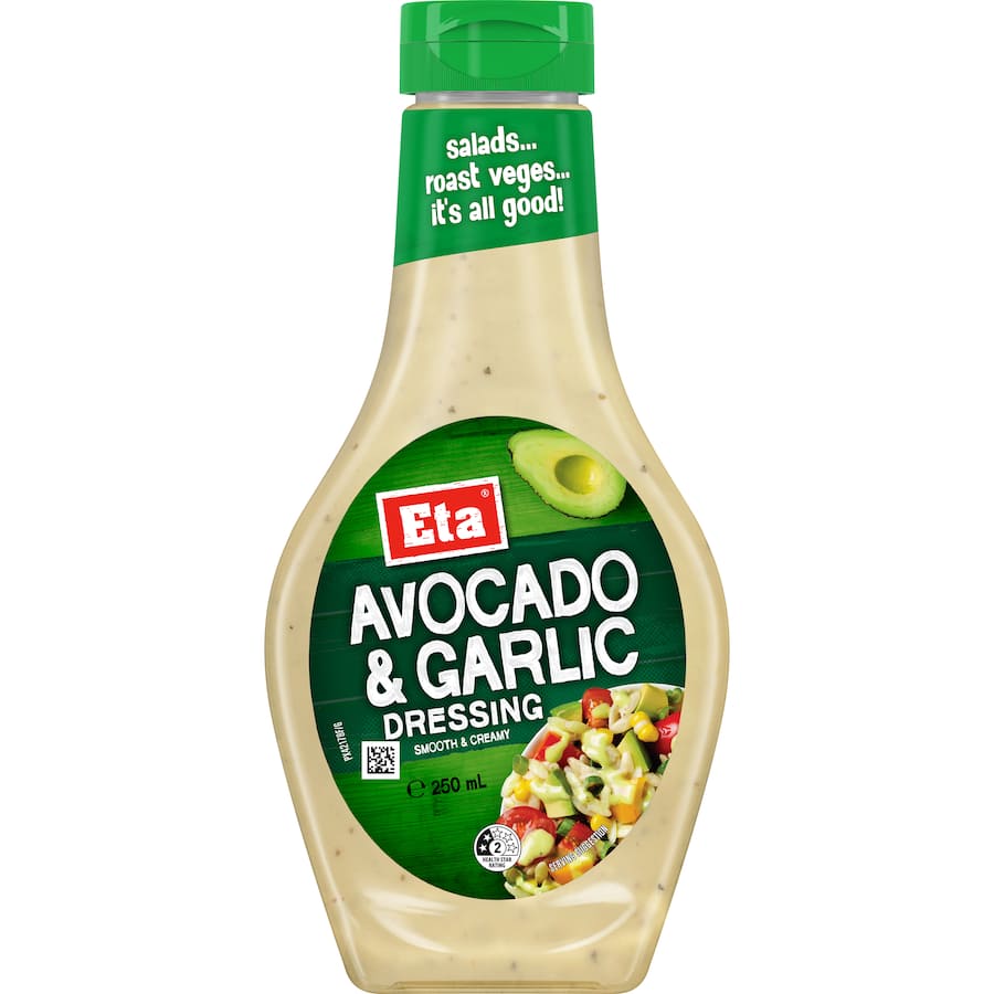 Creamy Eta Avocado & Garlic Dressing drizzled over a vibrant salad, showcasing avocado and garlic flavors.