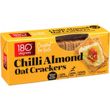 Crunchy chili almond oat crackers, batch-baked with whole grains, offering a spicy kick and healthy snacking option.