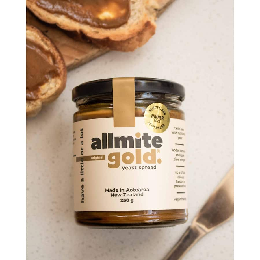 Creamy tahini-based Allmite Gold Yeast Spread with nutritional yeast, turmeric, and apple cider vinegar, vegan-friendly condiment.