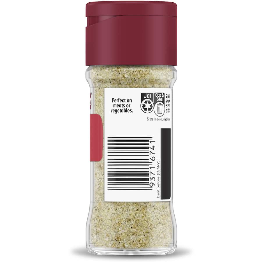 Garlic-infused salt in a glass shaker, perfect for enhancing flavors in omelettes, stir-frys, and salads.