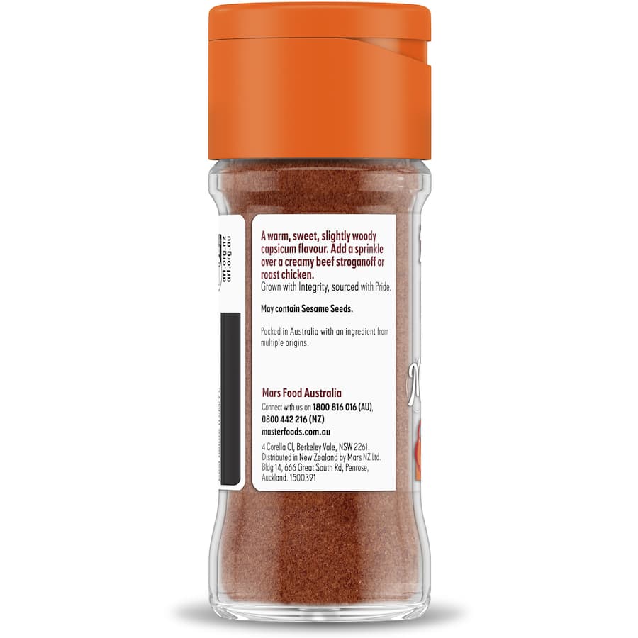 Ground paprika in a jar, showcasing a warm reddish hue, perfect for enhancing dishes with zesty flavor and depth.