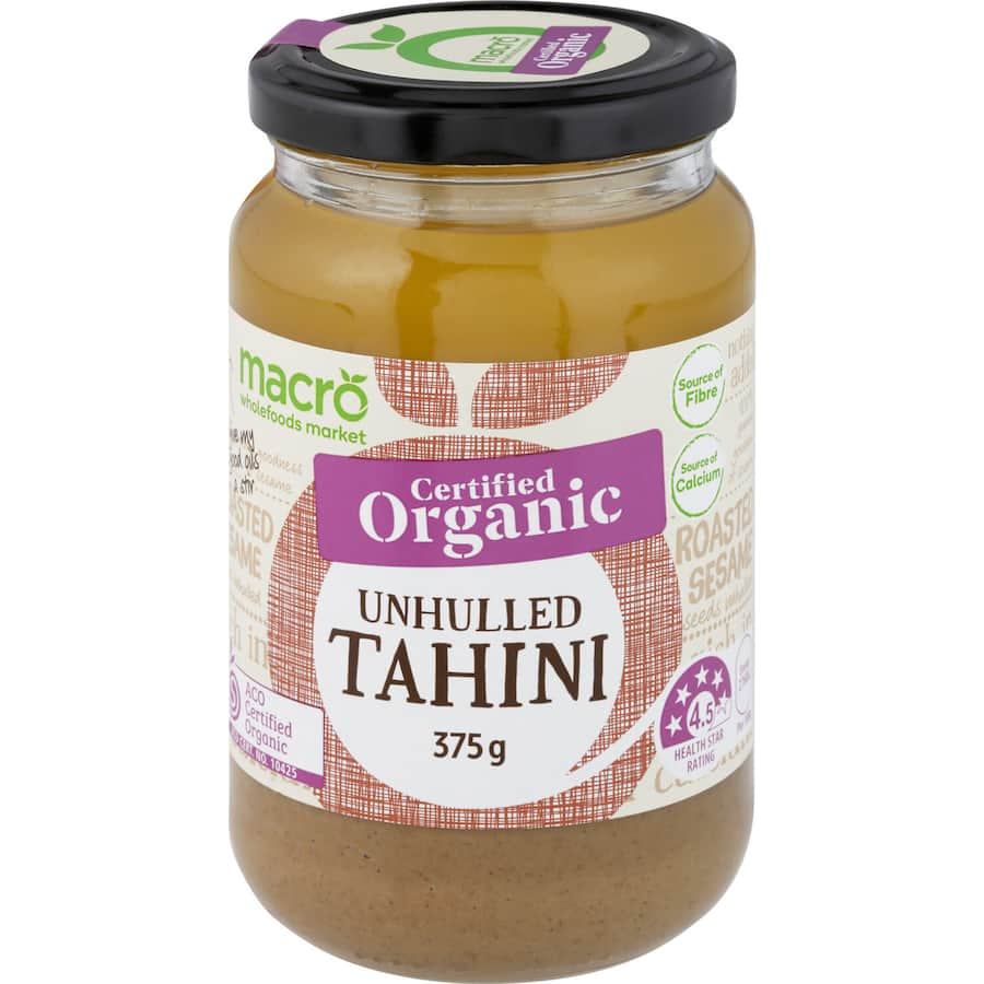 Macro Organic Unhulled Tahini in a jar, creamy texture with natural sesame oil separation, perfect for dips and dressings.